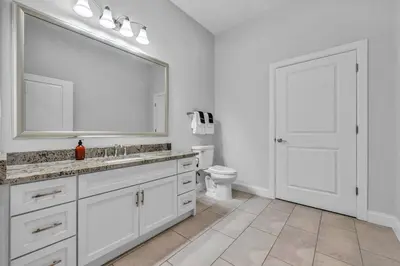 a bathroom with a sink and a toilet and a mirror at Ultra Chic Condo in The Heart of Downtown! in Cleveland