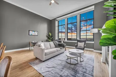 a living room with a couch and a table at Super LUX Downtown 1BD Condo | Gym | 24/7 Security in Cleveland