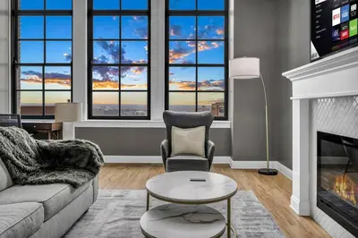 a living room with a couch and a fireplace at Super LUX Downtown 1BD Condo | Gym | 24/7 Security in Cleveland
