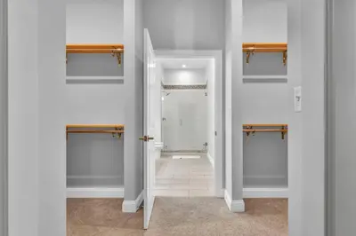 a bathroom with white walls and a walk in shower at Super LUX Downtown 1BD Condo | Gym | 24/7 Security in Cleveland