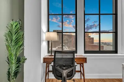 a desk with a chair in front of a window at Luxury Condo Heart of Downtown | 98/100 Walk Score in Cleveland