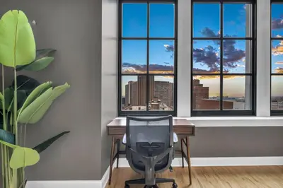 a desk with a chair in a room with windows at Premium Luxury Condo | Playhouse SQ | Parking $ in Cleveland