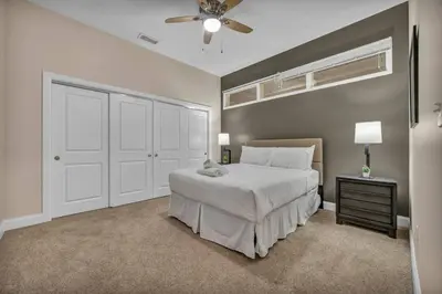 a bedroom with a white bed and a ceiling fan at Premium Luxury Condo | Playhouse SQ | Parking $ in Cleveland