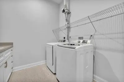 a white laundry room with a washer and dryer at Premium Luxury Condo | Playhouse SQ | Parking $ in Cleveland