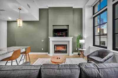 a living room with a couch and a fireplace at Luxury Condo in Playhouse Square: Walkers Paradise in Cleveland