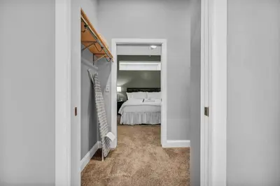 a white bedroom with a bed and a closet at The Halle Downtown 2BD | Parking/Gym/Security in Cleveland
