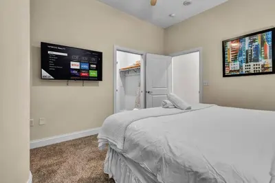 a bedroom with a bed and a flat screen tv at The Halle Downtown 2BD | Parking/Gym/Security in Cleveland