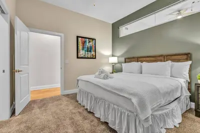 a bedroom with a large bed with a white comforter at The Halle Downtown 2BD | Parking/Gym/Security in Cleveland