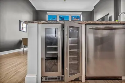 a kitchen with a counter with glass doors at The Halle Downtown 1BD | Parking/Gym/Security in Cleveland