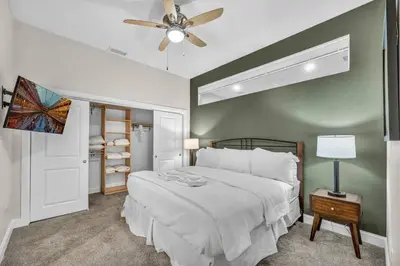 a bedroom with a bed and a ceiling fan at Downtown Luxury ~ King bed ~ Paid Parking ~ Wi-Fi in Cleveland