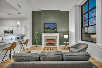 a living room with a couch and a fireplace at Downtown Luxury ~ King bed ~ Paid Parking ~ Wi-Fi in Cleveland