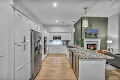 a kitchen with white cabinets and a marble counter top at Downtown Luxury ~ King bed ~ Paid Parking ~ Wi-Fi in Cleveland