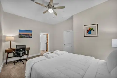 a bedroom with a bed and a desk and a ceiling fan at Downtown Luxury ~ King bed ~ Paid Parking ~ Wi-Fi in Cleveland