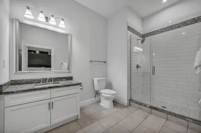 a bathroom with a toilet and a sink and a shower at Downtown Luxury ~ King bed ~ Paid Parking ~ Wi-Fi in Cleveland