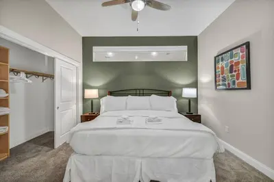 a bedroom with a large white bed and two lamps at Downtown Luxury ~ King bed ~ Paid Parking ~ Wi-Fi in Cleveland