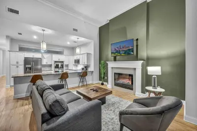 a living room with a couch and a fireplace at Downtown Luxury ~ King bed ~ Paid Parking ~ Wi-Fi in Cleveland