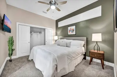 a bedroom with a white bed and a ceiling fan at HUGE Luxury Flat in Playhouse Square | Downtown in Cleveland