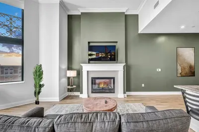 a living room with a couch and a fireplace at HUGE Luxury Flat in Playhouse Square | Downtown in Cleveland