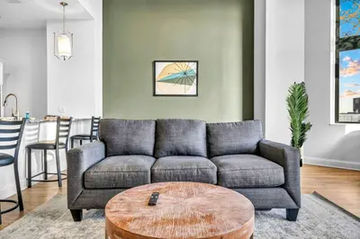 a living room with a couch and a table at HUGE Luxury Flat in Playhouse Square | Downtown in Cleveland