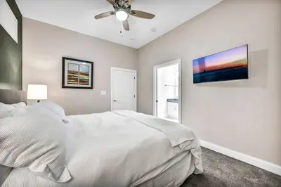 a bedroom with a white bed and a ceiling fan at HUGE Luxury Flat in Playhouse Square | Downtown in Cleveland