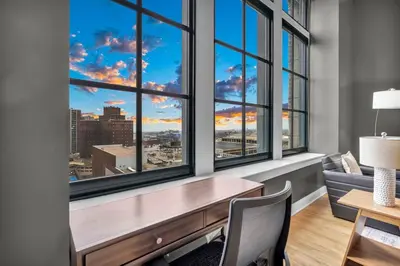 an office with a desk and windows with a view at Lux Flat Overlooking Guardians Field! Parking $ in Cleveland
