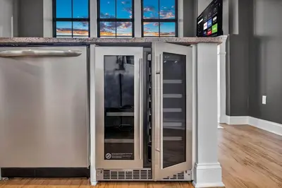 a stainless steel refrigerator in a room with windows at Lux Flat Overlooking Guardians Field! Parking $ in Cleveland