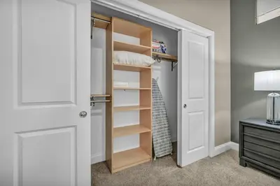 a walk in closet with a door and shelves at Lux Flat Overlooking Guardians Field! Parking $ in Cleveland