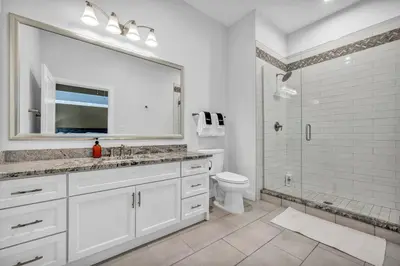 a bathroom with a sink and a toilet and a shower at Lux Flat Overlooking Guardians Field! Parking $ in Cleveland