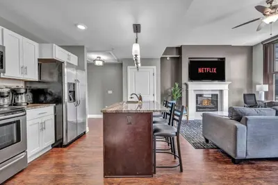a kitchen and living room with a couch and a table at Location! Playhouse Sq ~ Fast Wi-Fi ~ Walkscore 96 in Cleveland
