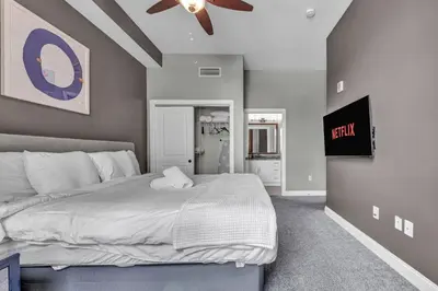 a bedroom with a large bed and a ceiling fan at Location! Playhouse Sq ~ Fast Wi-Fi ~ Walkscore 96 in Cleveland