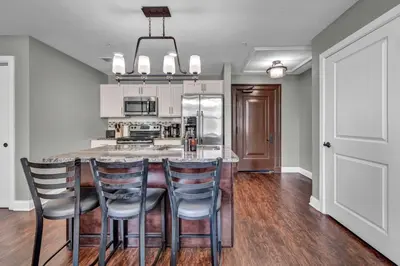 a kitchen with a large island with bar chairs at Location! Playhouse Sq ~ Fast Wi-Fi ~ Walkscore 96 in Cleveland