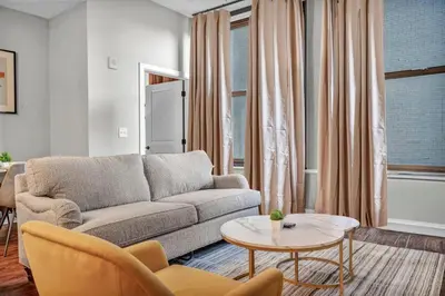 a living room with a couch and a table at Gorgeous Downtown Flat| Parking•Gym•Security in Cleveland