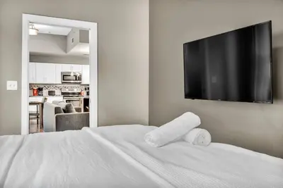 a bedroom with a white bed with two towels on it at LUXE Condo Downtown | Security•Gym•Parking in Cleveland