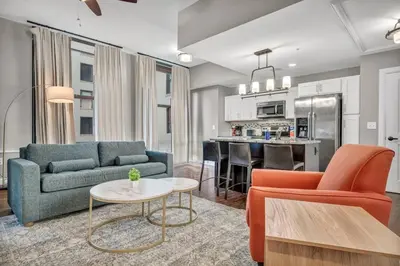 a living room with a couch and a table at LUXE Condo Downtown | Security•Gym•Parking in Cleveland