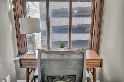 a desk with a chair in front of a window at LUXE Condo Downtown | Security•Gym•Parking in Cleveland