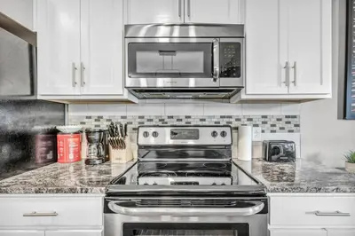 a kitchen with a stove and a microwave at Historic Loft in the Heart of Downtown • Gym in Cleveland