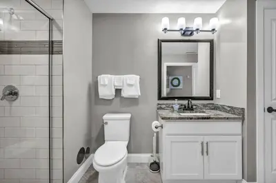 a bathroom with a toilet and a sink and a mirror at Historic Loft in the Heart of Downtown • Gym in Cleveland