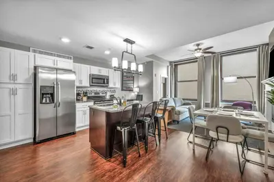 a kitchen and dining room with a table and chairs at Historic Loft in the Heart of Downtown • Gym in Cleveland