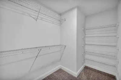 a walk in closet with white walls and shelves at Amazing Downtown Apartment in Incredible Location! in Cleveland