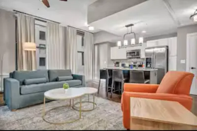 a living room with two blue couches and a table at Amazing Downtown Apartment in Incredible Location! in Cleveland