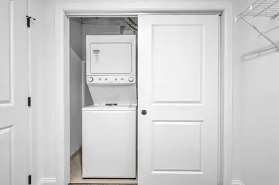 a kitchen with a refrigerator and a washer and dryer at Perfect Luxury Flat • Heart of Downtown • Gym in Cleveland