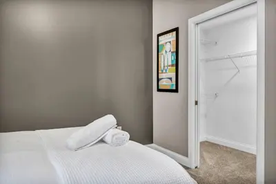 a bedroom with a white bed and a mirror at Perfect Luxury Flat • Heart of Downtown • Gym in Cleveland