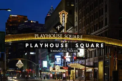 a playhouse square sign on a city street at night at Perfect Luxury Flat • Heart of Downtown • Gym in Cleveland