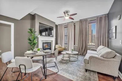 a living room with a couch and a table and chairs at Elegant Loft in the Heart of Downtown | Gym in Cleveland