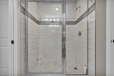 a shower with a glass door in a bathroom at Elegant Loft in the Heart of Downtown | Gym in Cleveland