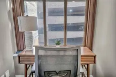 a window with a chair in front of a desk at Central Downtown Loft | Parking•Gym•Security in Cleveland