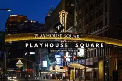 a play house square sign on a city street at night at Central Downtown Loft | Parking•Gym•Security in Cleveland