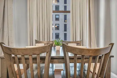 a dining room table with chairs and a window at Central Downtown Loft | Parking•Gym•Security in Cleveland