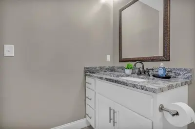 a bathroom with a sink and a mirror at Central Downtown Loft | Parking•Gym•Security in Cleveland