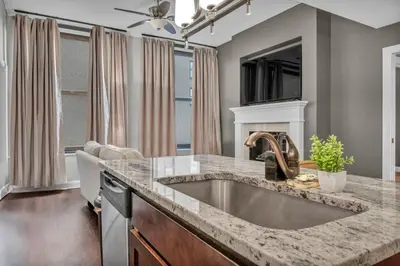 a kitchen with a large sink and a tv at Modern Loft in the Heart of Cleveland | Gym in Cleveland